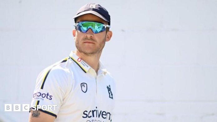 Sam Hain raises his bat to the crowd after scoring a half-century in the T20 Blast for Birmingham Bears