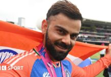 Virat Kohli celebrates with the flag of India after his side's T20 World Cup win in 2024