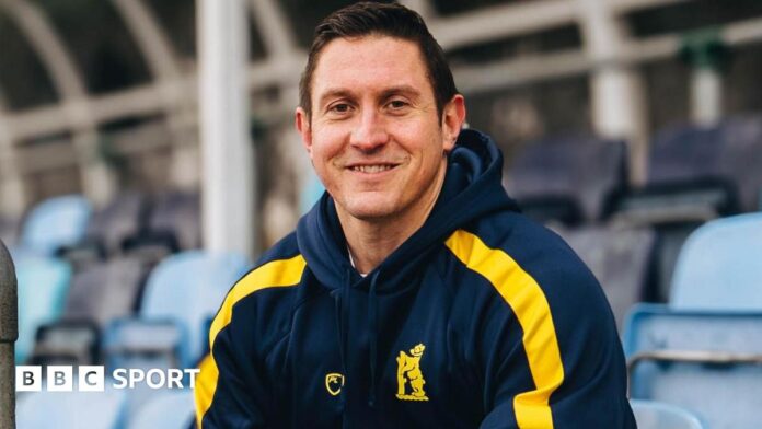 James Thomas sat in a stand at Edgbaston wearing his new Bears shirt