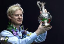 Neil Robertson lifts the World Grand Prix trophy after beating Stuart Bingham in the 2025 final