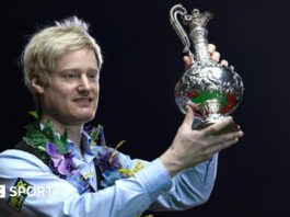 Neil Robertson lifts the World Grand Prix trophy after beating Stuart Bingham in the 2025 final