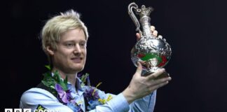 Neil Robertson lifts the World Grand Prix trophy after beating Stuart Bingham in the 2025 final