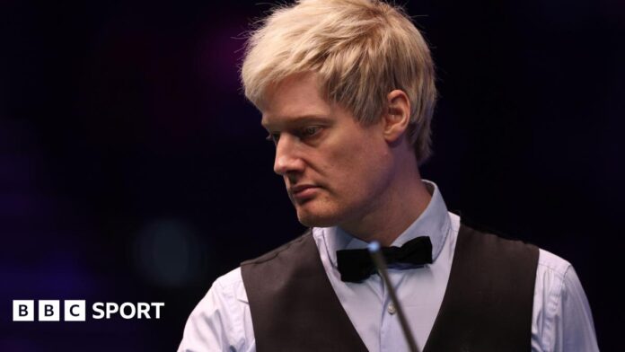 Neil Robertson looks on